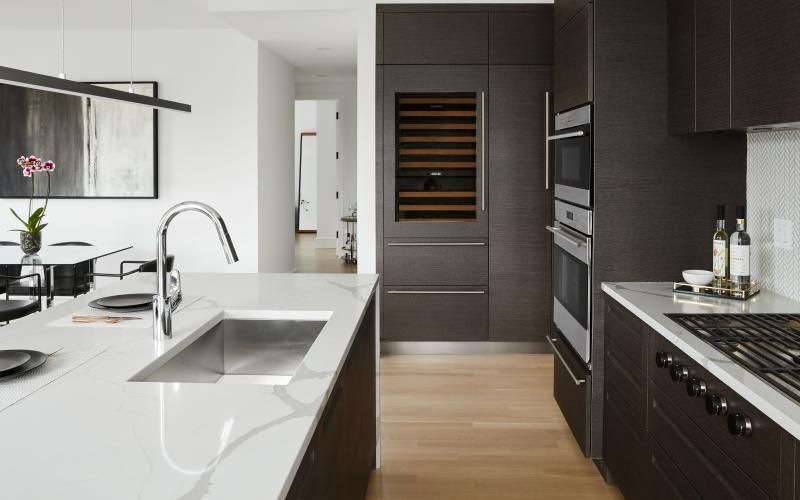 a kitchen with black cabinets